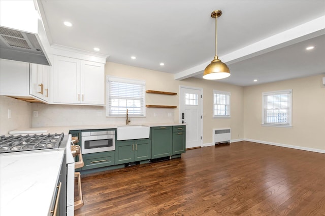 kitchen featuring ventilation hood, white cabinetry, sink, green cabinets, and gas range oven