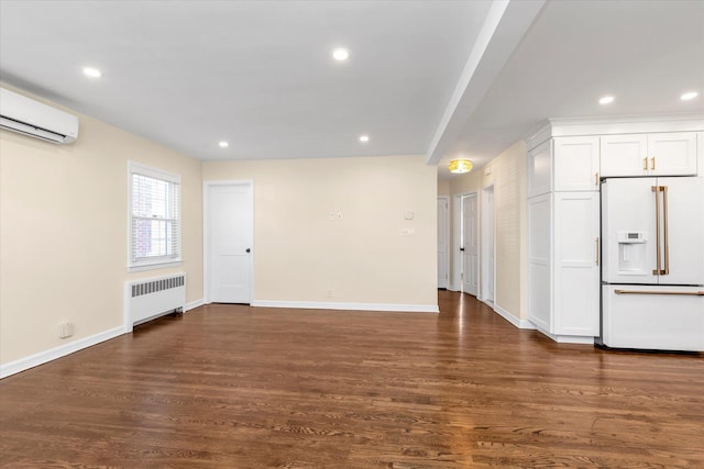 unfurnished living room featuring radiator, a wall mounted AC, and dark hardwood / wood-style flooring