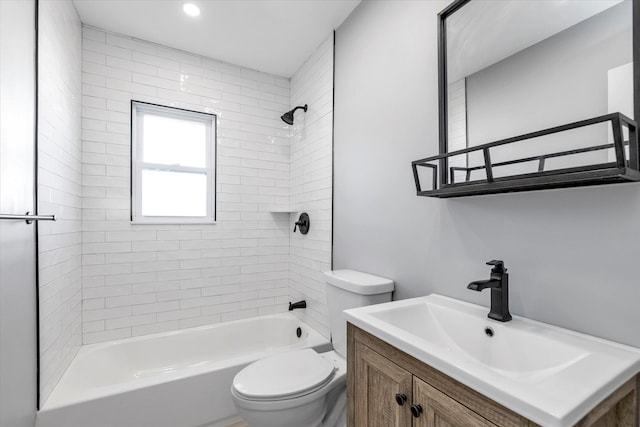 full bathroom with vanity, tiled shower / bath, and toilet