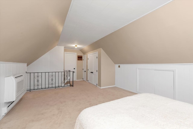 bedroom featuring vaulted ceiling and light colored carpet