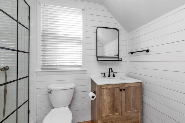 bathroom featuring vanity, vaulted ceiling, and toilet