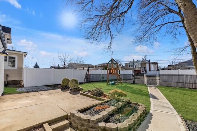 view of yard featuring a playground and a patio