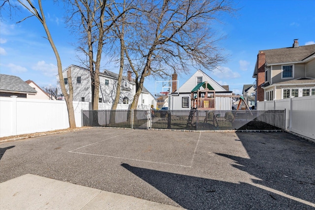 view of yard featuring a playground and basketball court