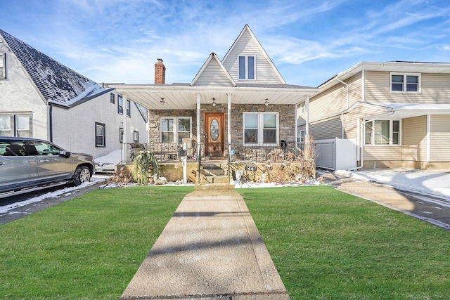 view of front of home with covered porch and a front yard