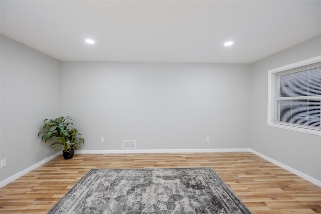 spare room featuring wood-type flooring