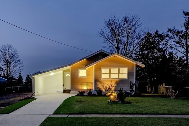 ranch-style house with a yard and a carport