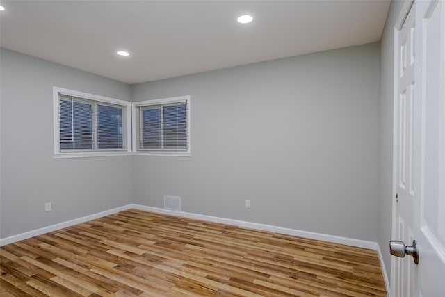 unfurnished room with light hardwood / wood-style floors