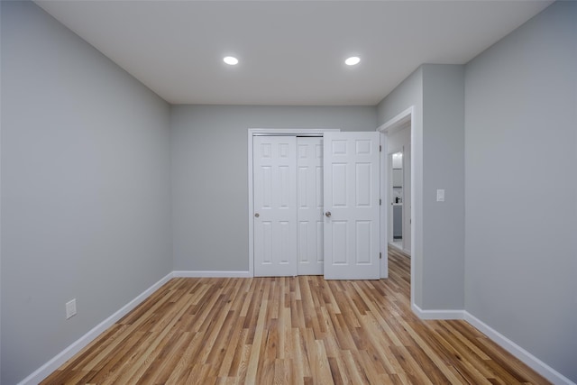 unfurnished bedroom featuring a closet and light hardwood / wood-style floors