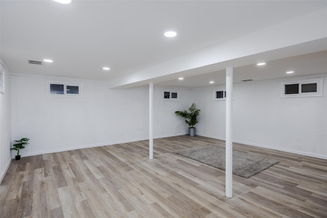 basement with light hardwood / wood-style floors