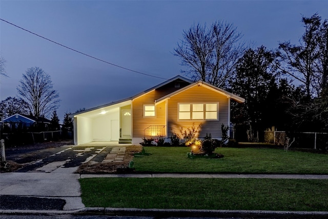 view of front of home featuring a lawn and a carport