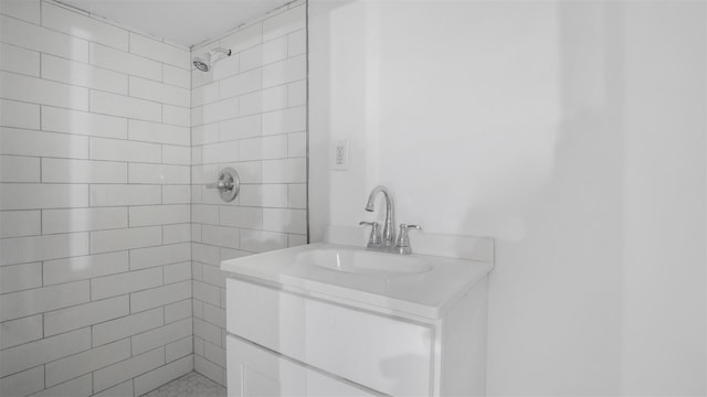 bathroom with vanity and tiled shower