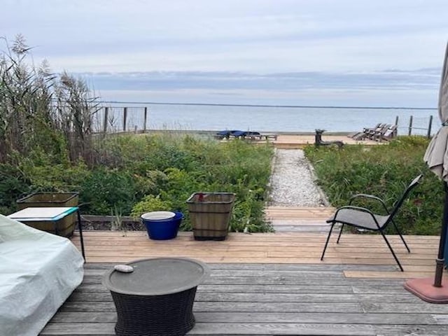 wooden deck featuring a water view