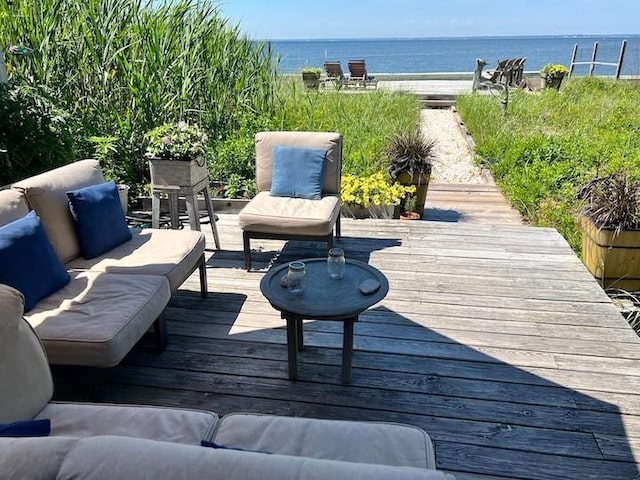 deck featuring a water view and outdoor lounge area