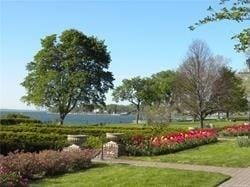 view of property's community with a lawn and a water view