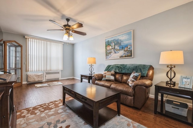 living room with ceiling fan, radiator, and wood-type flooring