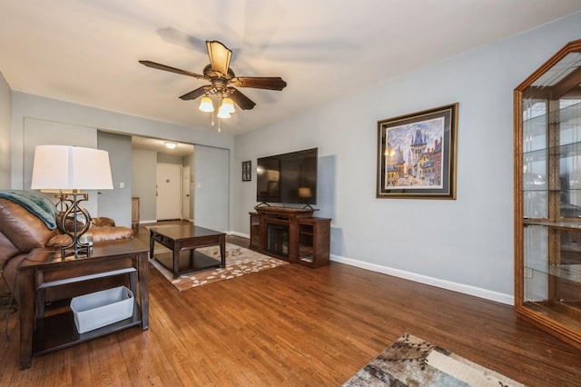 living room with ceiling fan and wood-type flooring