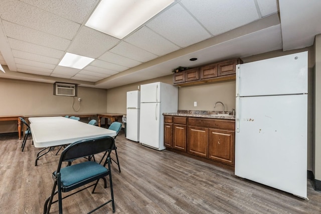 kitchen featuring a drop ceiling and white fridge