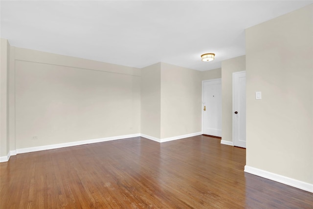 unfurnished room featuring dark hardwood / wood-style flooring