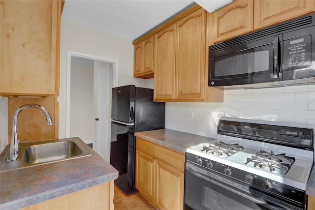 kitchen with sink, light tile patterned floors, black appliances, and tasteful backsplash