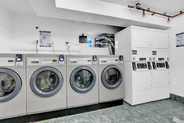 laundry area featuring separate washer and dryer and stacked washer / drying machine