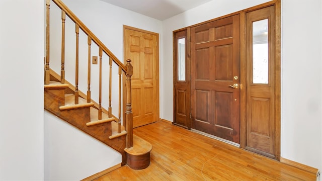 47A Old Squires Rd, Hampton Bays, NY 11946 - entryway featuring light wood-style flooring and stairs