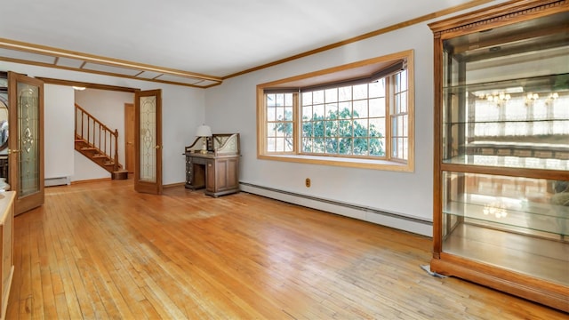 47A Old Squires Rd, Hampton Bays, NY 11946 - spare room featuring a baseboard radiator, stairs, crown molding, light wood-type flooring, and baseboard heating