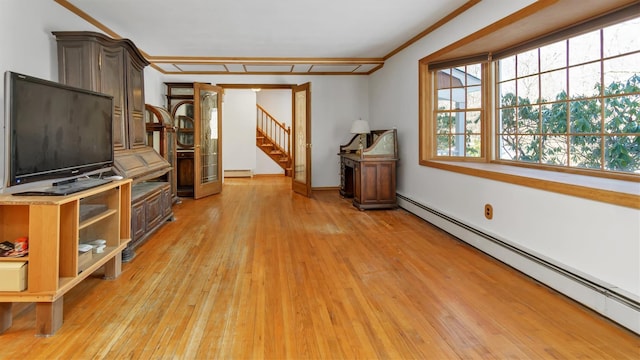 47A Old Squires Rd, Hampton Bays, NY 11946 - unfurnished living room featuring a baseboard radiator, light wood-type flooring, stairway, and baseboard heating