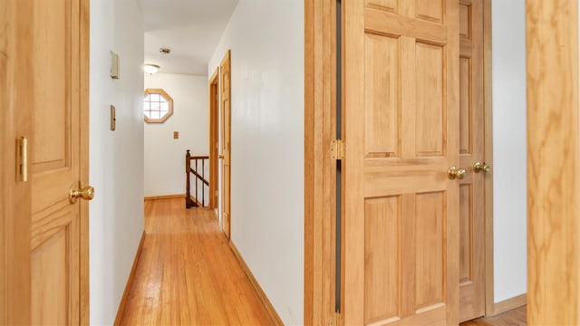 47A Old Squires Rd, Hampton Bays, NY 11946 - corridor with an upstairs landing and light wood-style floors