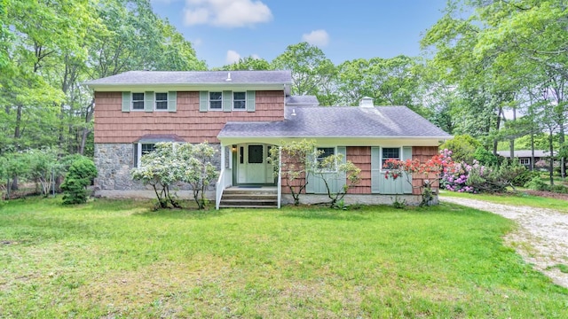 47A Old Squires Rd, Hampton Bays, NY 11946 - view of front of house with a front lawn, a chimney, and a shingled roof