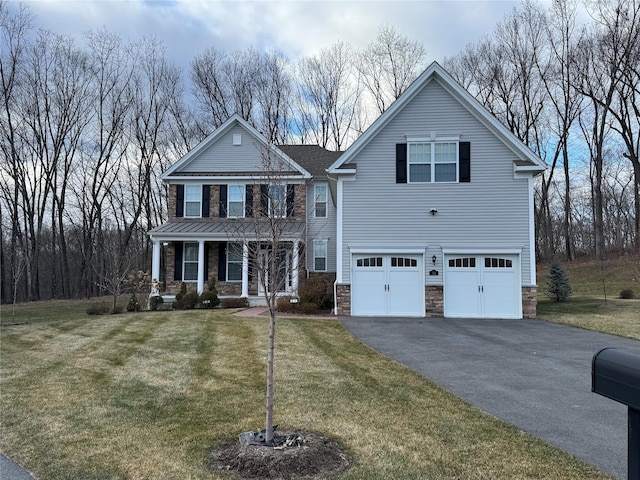 view of front of property with a front lawn, a garage, and a porch