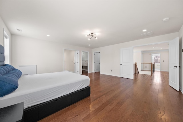 bedroom with dark wood-type flooring and multiple windows