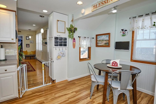 dining space with ceiling fan, plenty of natural light, and light hardwood / wood-style floors