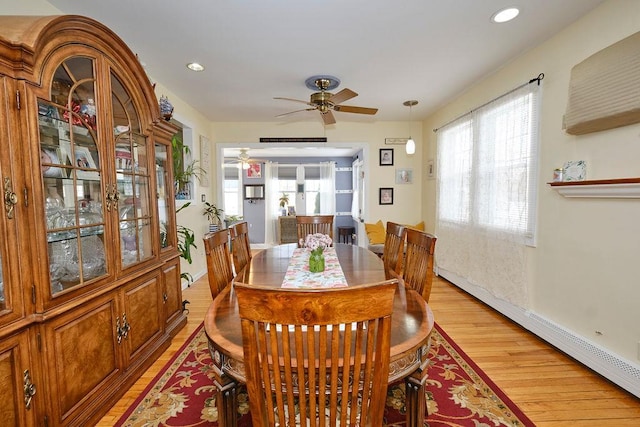 dining space featuring ceiling fan, light hardwood / wood-style floors, and baseboard heating