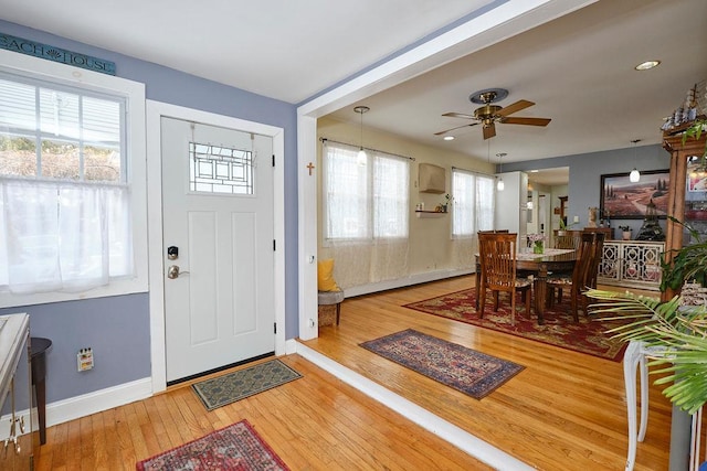 entrance foyer featuring ceiling fan, plenty of natural light, and wood-type flooring