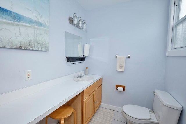 bathroom featuring vanity, tile patterned floors, and toilet