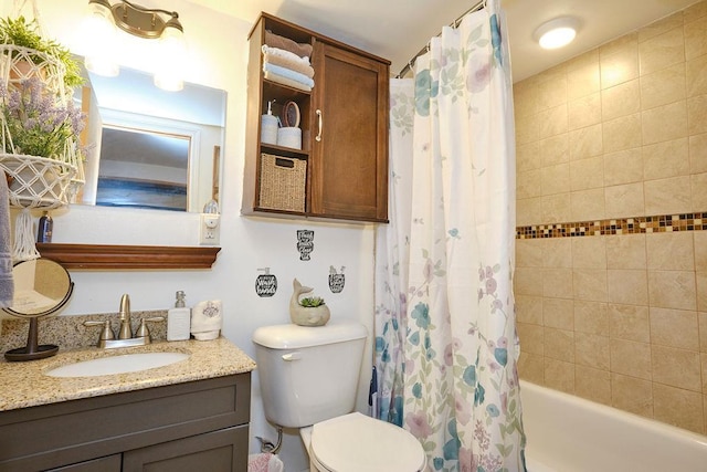 full bathroom with vanity, shower / tub combo with curtain, and toilet