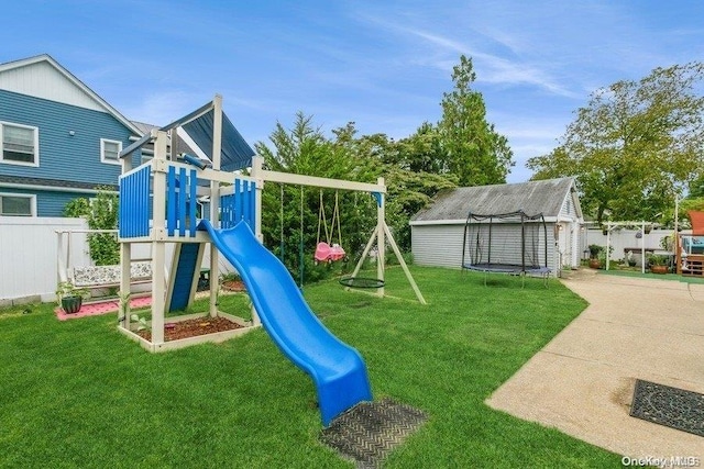 view of jungle gym with a trampoline, a lawn, and a storage unit