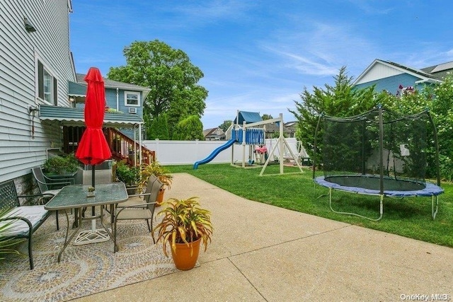 view of patio with a trampoline and a playground