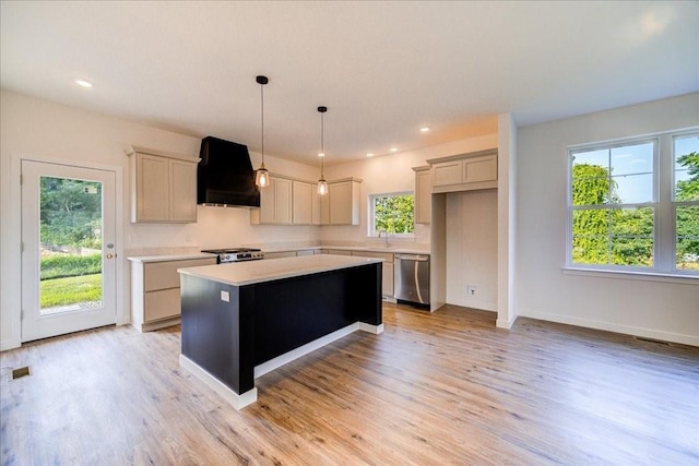 kitchen featuring premium range hood, gray cabinets, dishwasher, hanging light fixtures, and a kitchen island