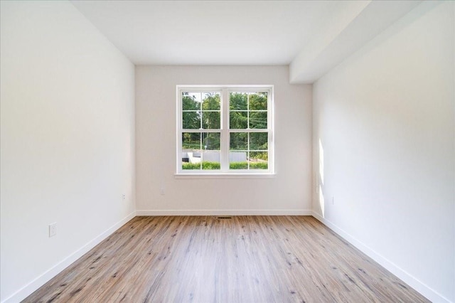 empty room with light hardwood / wood-style flooring