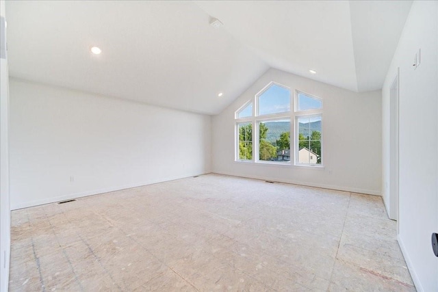 spare room with vaulted ceiling