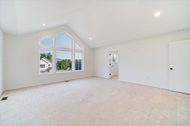 unfurnished room with lofted ceiling