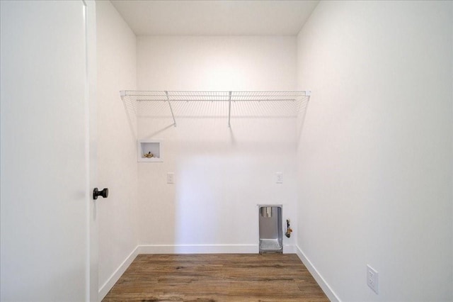 clothes washing area featuring washer hookup, dark hardwood / wood-style flooring, and hookup for a gas dryer