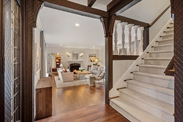 interior space with wood-type flooring and ornamental molding