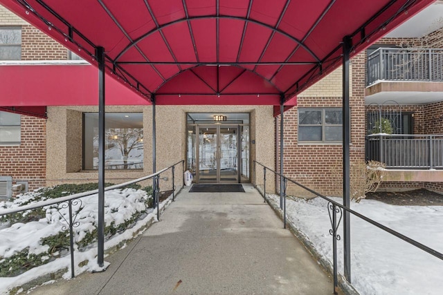 view of snow covered property entrance