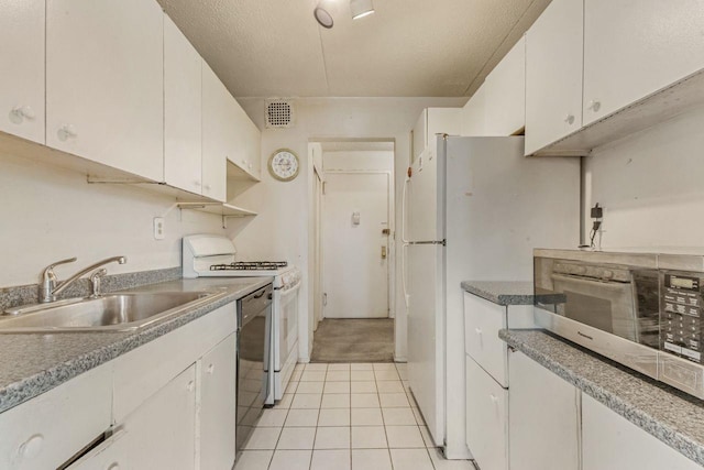 kitchen with white cabinetry, sink, white appliances, and a textured ceiling