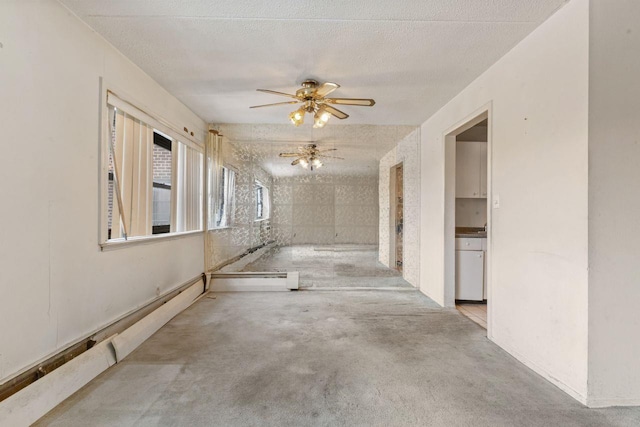 unfurnished room with a textured ceiling and ceiling fan