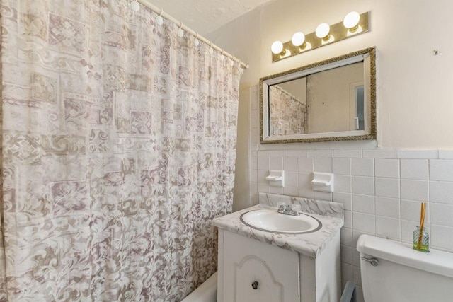 bathroom with vanity, a shower with curtain, tile walls, and toilet