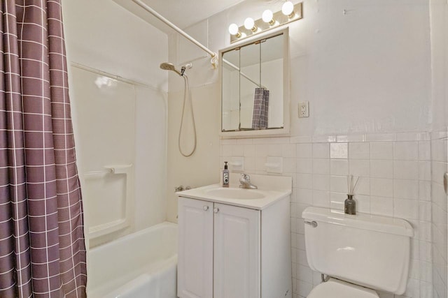 full bathroom featuring vanity, tile walls, shower / tub combo with curtain, and toilet