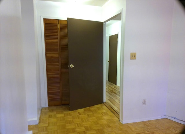 hallway featuring light parquet flooring